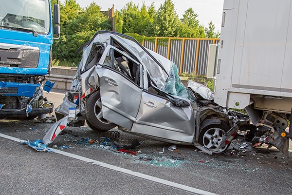 Mangled car sits between two large trucks in Fishkill, New York