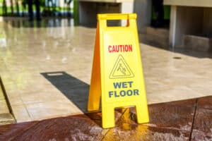 Caution wet floor sign placed on the ground to prevent slip and fall accidents